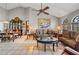 Spacious living room showcasing tile floors, comfortable sofas, a large painting, and adjacent dining area at 2209 Fairglenn Way, Winter Park, FL 32792