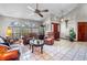 Bright living area with tile floors, ceiling fan, arched windows, and elegant furnishings at 2209 Fairglenn Way, Winter Park, FL 32792