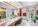 The bathroom features dual sinks, tiled floors, a garden tub, and a shower at 2209 Fairglenn Way, Winter Park, FL 32792