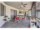 The screened porch features a ceiling fan and is furnished with a table and chairs at 2209 Fairglenn Way, Winter Park, FL 32792