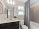Clean bathroom with dark vanity, white quartz countertop, and tiled shower/tub combo at 2241 Southbury Dr, Kissimmee, FL 34744