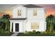 Charming two-story home with a black front door, white siding, lush landscaping and a welcoming curb appeal at 2241 Southbury Dr, Kissimmee, FL 34744