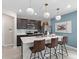 Modern kitchen with white countertops, stainless steel appliances, pendant lighting, and a breakfast bar at 2241 Southbury Dr, Kissimmee, FL 34744