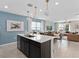 Bright kitchen featuring a center island, pendant lighting, and an open layout to the living room at 2241 Southbury Dr, Kissimmee, FL 34744