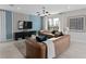 Comfortable living room features tan sofas, teal accent pillows, large windows, and stylish decor at 2241 Southbury Dr, Kissimmee, FL 34744