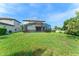 A large backyard and screened-in pool provide ample outdoor space at 235 Aidans Lndg, Haines City, FL 33844