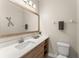 Well-lit bathroom with a modern vanity, large mirror, and ample counter space at 235 Aidans Lndg, Haines City, FL 33844