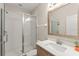Modern bathroom with glass shower, white tile, and wood vanity at 235 Aidans Lndg, Haines City, FL 33844