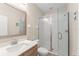 Modern bathroom with glass shower enclosure, neutral walls, and wood vanity at 235 Aidans Lndg, Haines City, FL 33844