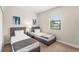 Bedroom with twin beds, large window, and neutral decor at 235 Aidans Lndg, Haines City, FL 33844