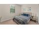 Bright bedroom with two beds, a window, and a mirrored nightstand at 235 Aidans Lndg, Haines City, FL 33844