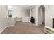 Open loft area that features neutral carpet, a window for natural light, and an arched doorway at 235 Aidans Lndg, Haines City, FL 33844