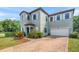 Beautiful home featuring a brick driveway, two-car garage, and manicured landscaping at 235 Aidans Lndg, Haines City, FL 33844
