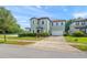 Charming two-story home with a brick driveway, two-car garage and well-manicured lawn at 235 Aidans Lndg, Haines City, FL 33844