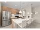 Well-lit kitchen with a stainless steel refrigerator and a center island with barstool seating at 235 Aidans Lndg, Haines City, FL 33844