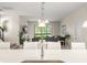 Bright kitchen flowing to living area, featuring a spacious island and modern decor at 235 Aidans Lndg, Haines City, FL 33844