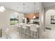 Modern kitchen with sleek wood cabinetry, quartz countertop island, and stainless steel appliances at 235 Aidans Lndg, Haines City, FL 33844