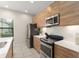 Well-designed kitchen boasting wood cabinets, stainless steel appliances, and white countertops at 235 Aidans Lndg, Haines City, FL 33844