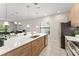 Open-concept kitchen featuring a large island, stainless steel appliances, and modern lighting at 235 Aidans Lndg, Haines City, FL 33844