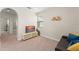Neutral living room features a media console, sofa, and large archway at 235 Aidans Lndg, Haines City, FL 33844