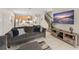 Comfortable living room that opens to a modern kitchen and dining area with a staircase at 235 Aidans Lndg, Haines City, FL 33844