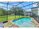 Relaxing screened in pool area with lush green lawn at 235 Aidans Lndg, Haines City, FL 33844