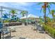 Outdoor lounge area near the community pool with event stage, tent, and ample seating at 235 Aidans Lndg, Haines City, FL 33844