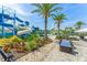 Resort-style community pool and slides with tropical landscaping and lounge seating at 235 Aidans Lndg, Haines City, FL 33844