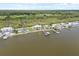 Aerial view of waterfront homes with private docks on a picturesque coastline at 291 River Rd, Oak Hill, FL 32759