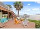 The backyard deck is furnished and overlooks the water at 291 River Rd, Oak Hill, FL 32759