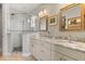 Bright bathroom featuring double vanity, granite countertops, and glass shower with decorative tile accents at 291 River Rd, Oak Hill, FL 32759