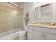 Bathroom featuring a shower and tub combination, updated vanity and a decorative mirror at 291 River Rd, Oak Hill, FL 32759