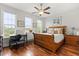 Bedroom with hardwood floors, natural light, and a charming desk area with scenic outdoor views at 291 River Rd, Oak Hill, FL 32759