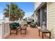 Outdoor deck with comfortable seating and serene palm tree views, perfect for relaxation and enjoying the scenery at 291 River Rd, Oak Hill, FL 32759