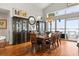 Elegant dining room with wood floors, display cabinets, and waterfront view at 291 River Rd, Oak Hill, FL 32759