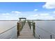 This dock extends far out over the water, offering stunning views at 291 River Rd, Oak Hill, FL 32759