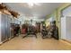 Well-lit exercise room, complete with gym equipment, desk, and storage cabinets at 291 River Rd, Oak Hill, FL 32759