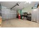 Spacious garage with workbench, cabinets, and epoxy flooring at 291 River Rd, Oak Hill, FL 32759