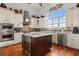 Gourmet kitchen with stainless steel appliances, custom cabinets, and a wine fridge at 291 River Rd, Oak Hill, FL 32759