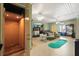 Spacious living area with an elevator, golf putting green, and comfortable seating at 291 River Rd, Oak Hill, FL 32759