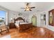 Bedroom with wood floors, ceiling fan, views and ensuite bathroom access at 291 River Rd, Oak Hill, FL 32759