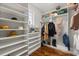 Walk-in closet featuring custom shelving, hardwood floors and natural light at 291 River Rd, Oak Hill, FL 32759