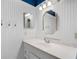 Bathroom featuring white beadboard walls, vanity, and decorative lighting at 3055 Dellcrest Pl, Lake Mary, FL 32746