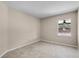 An empty bedroom with neutral walls, tile flooring, a ceiling fan, and a bright window showing the yard at 3055 Dellcrest Pl, Lake Mary, FL 32746