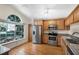 Bright kitchen featuring stainless steel appliances, granite countertops, wood cabinets, and a large window at 3055 Dellcrest Pl, Lake Mary, FL 32746