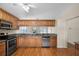 Well-equipped kitchen featuring stainless steel appliances, wood cabinets, and granite countertops at 3055 Dellcrest Pl, Lake Mary, FL 32746