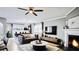 An open concept living room shows the fireplace, chandelier, windows, and sofas at 3055 Dellcrest Pl, Lake Mary, FL 32746