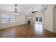 Bright living room featuring a fireplace, wood floors, a ceiling fan, and French doors to the pool at 3055 Dellcrest Pl, Lake Mary, FL 32746