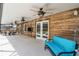 A large covered patio features wood plank walls, three fans, outdoor furniture, and pool access at 3055 Dellcrest Pl, Lake Mary, FL 32746