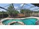 Inviting screened-in pool and spa surrounded by lush landscaping, perfect for relaxation and outdoor enjoyment at 3055 Dellcrest Pl, Lake Mary, FL 32746